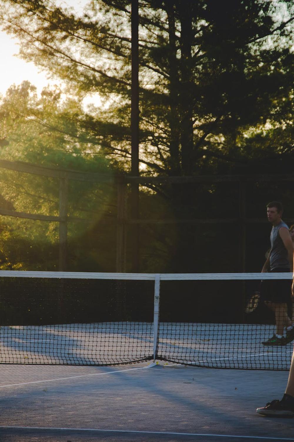 photo_of_three_men_playing_tennis